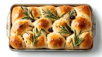 Freshly baked focaccia bread with rosemary sprigs and olives on baking tray, golden crust and soft texture, ready to serve for dinner.
