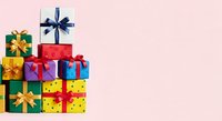 Colorful gift boxes stacked with ribbons and bows on pink background, isolated for holiday, birthday, and celebration design projects.