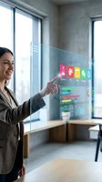 Professional businesswoman interacting with futuristic holographic interface displaying colorful data analytics and charts in modern office environment.