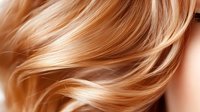 Flowing golden blonde hair strands in motion against soft background, highlighting natural shine and movement for beauty and haircare advertising.