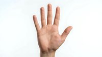 Male hand showing open palm gesture isolated on white background for communication and body language concepts.
