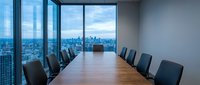 Modern corporate boardroom with wooden conference table and city skyline view through floor-to-ceiling windows for business meetings and presentations.