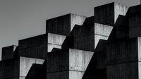 Brutalist concrete architecture with bold geometric shapes and deep shadows, captured in dramatic black and white for modern design projects.