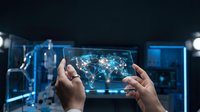 Hands holding transparent tablet displaying global network connections with glowing nodes and data visualization in futuristic tech environment.
