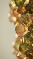 Macro close-up of translucent amber and green glass beads with soft bokeh background for jewelry design and crafting projects.