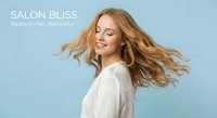 Young blonde woman with flowing hair in white shirt smiling joyfully against blue background for beauty and wellness advertising campaigns.