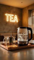 Boiling glass electric kettle and teapot on copper tray with glowing neon TEA sign in cozy warm cafe interior.