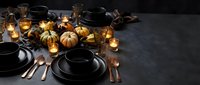Elegant autumn table setting with black dinnerware, copper cutlery, mini pumpkins and warm candlelight creating cozy seasonal dining atmosphere.