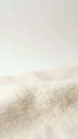 Closeup of natural linen fabric with soft texture and neutral beige tone, showcasing woven material suitable for textile design, home decor, and fashion projects.
