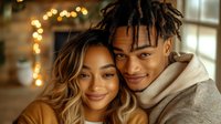 Young African American couple sharing intimate moment, smiling with warm bokeh lights in background. Romantic lifestyle portrait showing authentic connection.