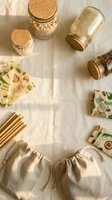 Zero waste lifestyle flat lay with glass jars, bamboo straws, reusable bags and eco-friendly kitchen storage containers on marble surface.