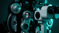 Close-up of mechanical gears and metal components with turquoise lighting, showcasing industrial machinery parts and mechanical engineering design for technical and manufacturing concepts.