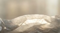 Abstract flowing fabric waves in soft beige and cream tones with gentle lighting creating elegant textile movement for luxury design projects.