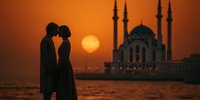 Romantic couple silhouette embracing at sunset with mosque minarets in background. Golden hour waterfront scene for wedding, travel, romance concepts.