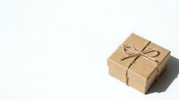 Small kraft paper gift box tied with natural twine bow on white background, isolated for packaging design and holiday presentations.