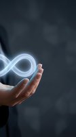 Hand holding glowing infinity symbol representing endless possibilities, sustainability, and circular economy concepts for business and technology applications.