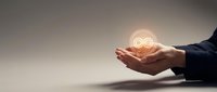 Businessman hand holding glowing infinity symbol representing endless possibilities, sustainable growth, and continuous improvement for corporate success and innovation concepts.