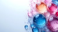 Colorful liquid drops and bubbles in pink and blue tones on light background with water splashes and reflections create abstract macro composition.