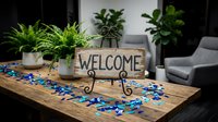 Rustic wooden welcome sign with metal stand on table surrounded by green houseplants and blue decorative elements in modern living room interior.