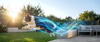 Young male athlete in mid-air performing parkour jump over obstacle in suburban backyard at sunset, with digital blue energy wave effects overlaid, representing motion and athletic performance.