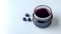 Fresh blueberry jam or preserve in glass jar with whole berries on white background, homemade organic food concept.