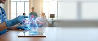 Cardiologist examining digital heart hologram on tablet with medical team in background, healthcare technology and cardiology diagnosis concept.