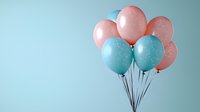 Festive bunch of pink and blue pastel balloons with delicate speckled texture floating against soft turquoise background, creating gentle gender reveal party atmosphere.