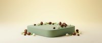 Green cylindrical podium platform with scattered autumn acorns on neutral beige background for product display and presentation purposes.