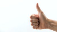 Hand showing thumbs up gesture on white background isolated for positive feedback and approval concepts in business and communication.