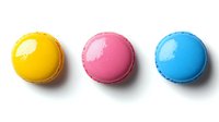 Three colorful macarons in yellow, pink and blue arranged in row on white background. French pastry dessert cookies isolated for bakery menu design.