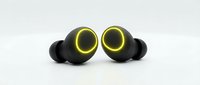 Pair of black wireless earbuds with glowing yellow ring accents, isolated on white background, ready for tech product design and marketing use.