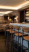 Modern luxury bar interior with marble countertop, wooden bar stools, and warm ambient ceiling lighting. Ideal for hospitality, restaurant, and upscale venue design projects.