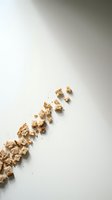 Scattered cereal pieces arranged diagonally on white background, isolated and ready for design use in food marketing, breakfast advertising, and nutritional content layouts.