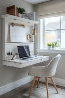 Minimalist wall-mounted desk workspace with laptop, modern chair, and brass sconce light creates efficient home office setup near bright window with natural light.
