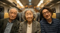 Three generations of Asian family members smiling together while traveling on modern train, elderly grandparents with adult son enjoying comfortable journey.