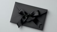 Black envelope with elegant satin bow on dark background, minimalist luxury design concept for exclusive invitations and special occasions.