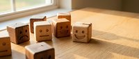 Wooden blocks with carved emoji faces showing various emotions arranged on a sunlit table, representing mood tracking and mental health concepts.