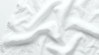 Crumpled white fabric with soft folds and wrinkles creating texture and depth, suitable for backgrounds, textile design, and product mockups.