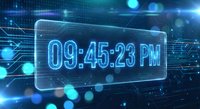 Futuristic digital clock display showing time 09:45:23 PM on transparent glass panel with glowing blue circuit board background and bokeh light effects.