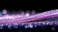 Magical purple and pink glitter particles floating on black background with bokeh light effects create dreamy atmospheric composition.