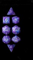 Purple polyhedral dice set with cosmic swirl pattern for tabletop gaming and role-playing adventures on dark background.