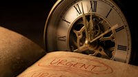 Antique brass skeleton clock with exposed gears displayed next to urgent stamped document on dark background, symbolizing time pressure and deadline management for business concepts.