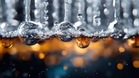 Macro photography of water drops with amber and blue bokeh background creating magical atmosphere. Crystal clear spheres reflect light in artistic composition.