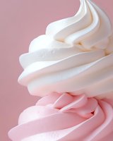 Creamy white and pink swirled frosting with smooth texture on pastel background for bakery dessert and confectionery design projects.