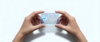 Young adult hands holding transparent futuristic card with glowing text against white background, suitable for technology, innovation, and digital business concepts.