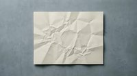 Crumpled white paper texture with wrinkled surface and natural folds creating abstract geometric patterns for graphic design and creative projects.