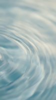 Soft water ripples with gentle wave patterns in serene blue and white tones, creating a calming abstract background suitable for wellness and spa designs.