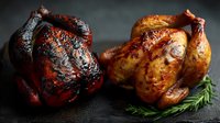 Two whole roasted chickens on dark slate, one with crispy blackened skin and one golden brown, garnished with fresh rosemary sprigs for gourmet food photography.