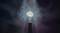 Glowing light bulb with brain filament surrounded by floating question marks in smoky atmosphere representing creative thinking and problem solving concepts.