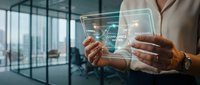 Businessman holding transparent digital tablet with holographic interface in modern office environment with glass partitions and cityscape view.